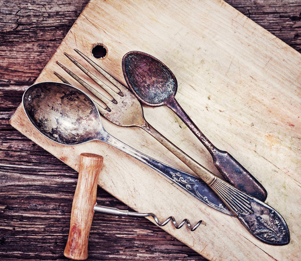 closeup view of vintage kitchen utensils over wooden table - Foto, imagen