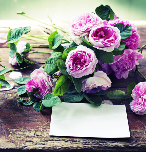 Amazing pink flowers with white paper for copy space on wooden background - Foto, Imagen