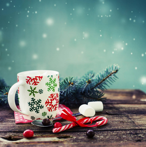 closeup view of coffee cup with marshmallows and christmas decorations over wooden table - Фото, изображение