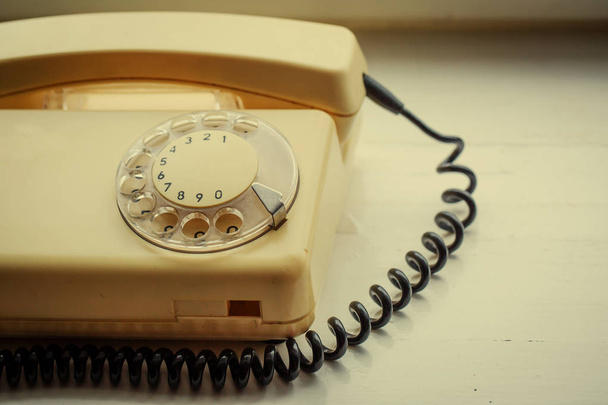close up on retro vintage telephone on wooden table - Фото, зображення