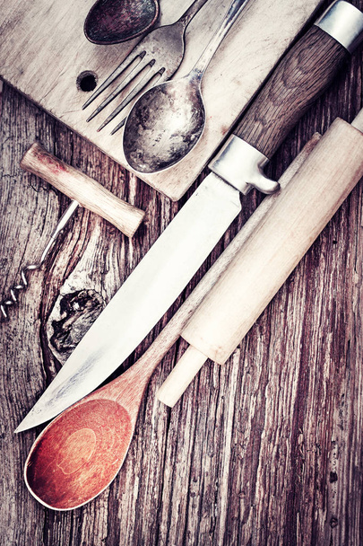 closeup view of vintage kitchen utensils over wooden table - 写真・画像