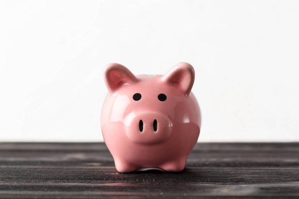 piggy bank on the old wooden background - Photo, image