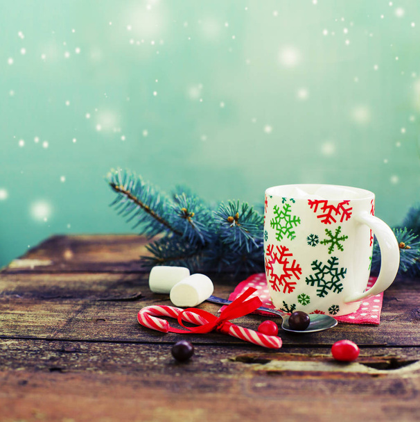 closeup view of coffee cup with marshmallows and christmas decorations over wooden table - Zdjęcie, obraz