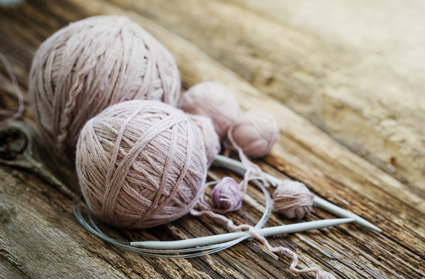 Colorful threads and knitting needles on wooden background - Valokuva, kuva