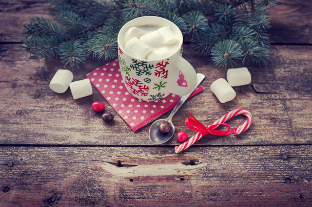 closeup view of coffee cup with marshmallows and christmas decorations over wooden table - Foto, immagini
