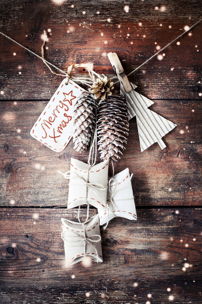 closeup view of christmas decorations in vintage style hanging on rope over wooden background - Photo, Image