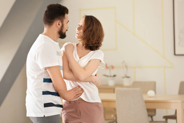 Lovely couple dancing together at home - Foto, afbeelding