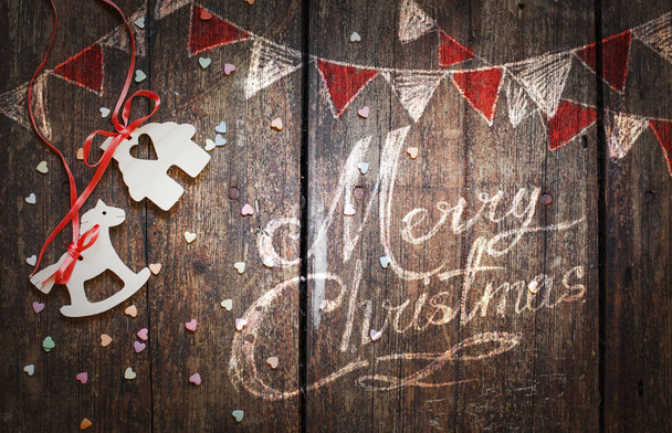 closeup view of wooden christmas decorations in vintage style with painted pictures over wooden background - Photo, Image