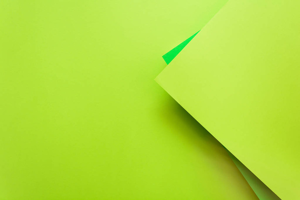 Green and lime pastel color papered background. Volume geometric flat lay. Top view. Copy space - 写真・画像