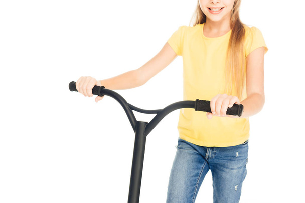 cropped shot of happy child holding scooter isolated on white - Zdjęcie, obraz
