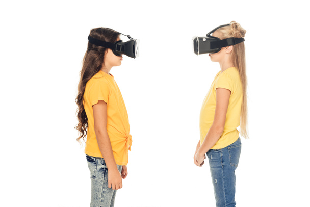 side view of cute kids using virtual reality headsets isolated on white - Фото, зображення