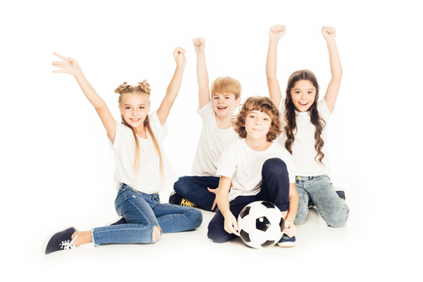 happy kids with soccer ball raising hands and smiling at camera isolated on white - Zdjęcie, obraz