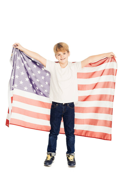 smiling adorable boy holding american flag and looking at camera isolated on white - Photo, Image
