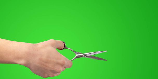 Woman hand with  scissors isolated on color background - Fotó, kép