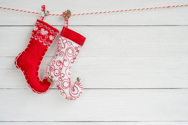 Christmas background. Colorful Christmas socks on white wooden background. Copy space, top view. Christmas symbol. - Fotografie, Obrázek