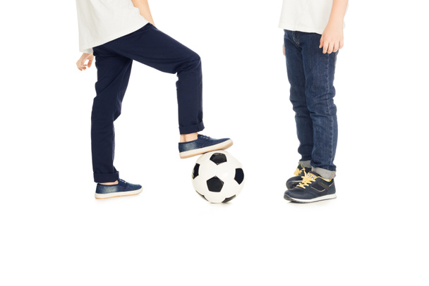 обрезанное изображение мальчиков, играющих с футбольным мячом изолированы на белом
 - Фото, изображение
