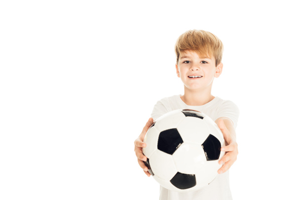 smiling adorable boy showing football ball isolated on white - Fotó, kép