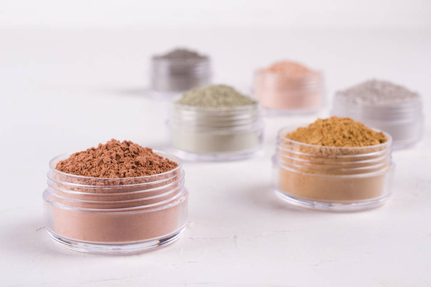 Set of different cosmetic clay mud powders on white background - Foto, afbeelding