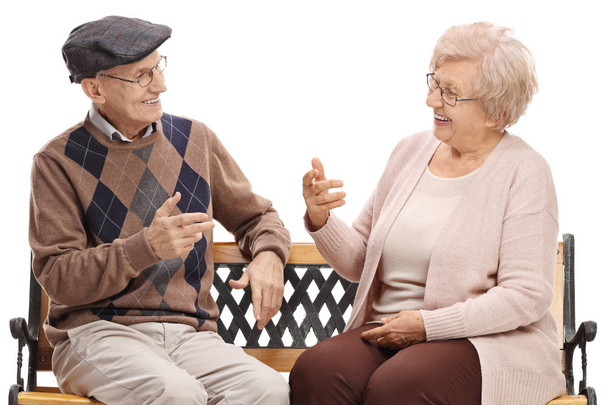 Seniors sitting on a bench and talking isolated on white background - Foto, Imagem