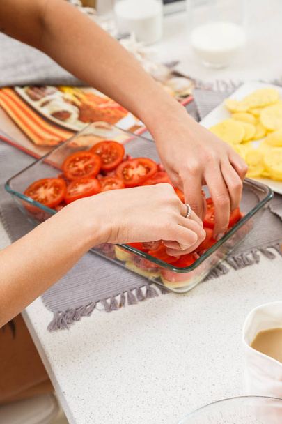 Closeup of female hands cooking tasty meat with vegetables - Foto, immagini