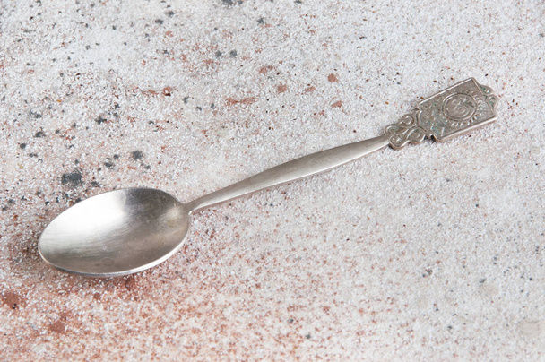 Metal vintage tea spoon on concrete background. Copy space for text - Photo, Image