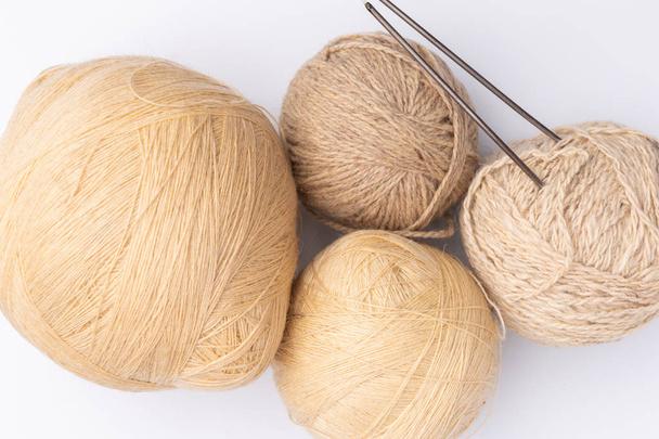 wool, skeins of yarn and knitting needles on white background - Фото, изображение