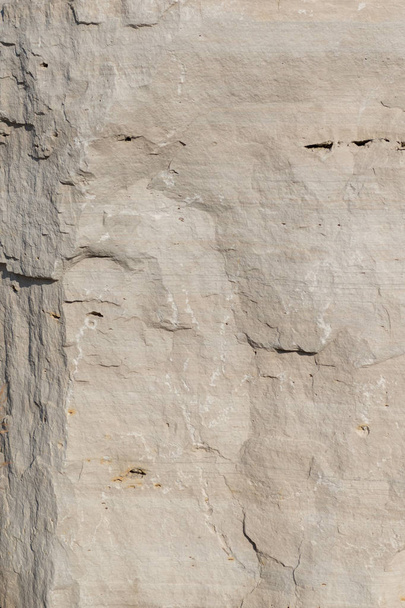 Closeup limestone rock face showing weathered strata for a greologival, natural wallpaper or backdrop - Photo, Image