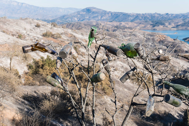 Zebrane butelki szklane i widoki na obrażenia od ognia Thomas na wzgórzach wokół jeziora Casitas w Ojai, Kalifornia - Zdjęcie, obraz