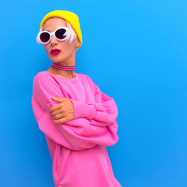 Blonde Girl in fashion accessories. Beanie Cap, Sunglasses and choker. Colorful trendy urban street vibes - Foto, immagini