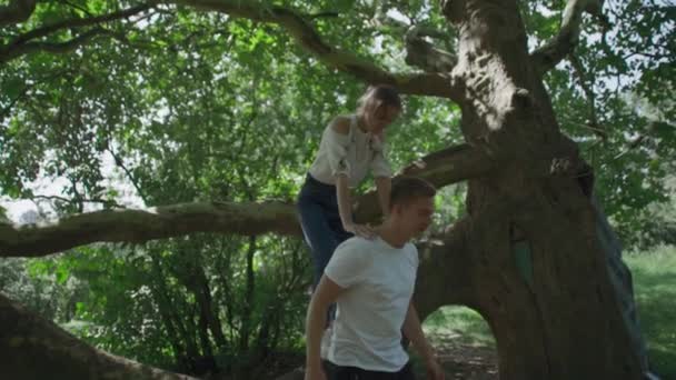 Young couple is spinning around in the park - Video