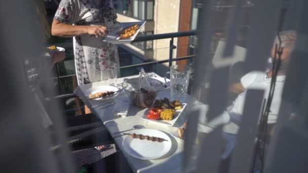 Family dinner on the balcony of the apartment - Footage, Video