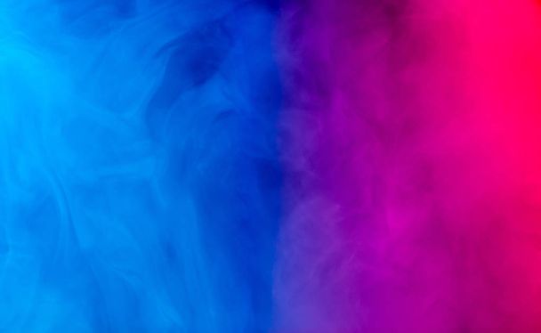 merging of colorful smoke on dark background - Photo, Image