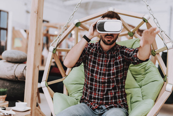 Relaxation. Virtual Reality Glasses. Create Ideas. Inspiration. Creative Worker. Hanging Chair. Sit. Brainstorm. Young Guy. Businessman. Working in Office. Businesspeople. Workplace. Comfortable. - Foto, imagen