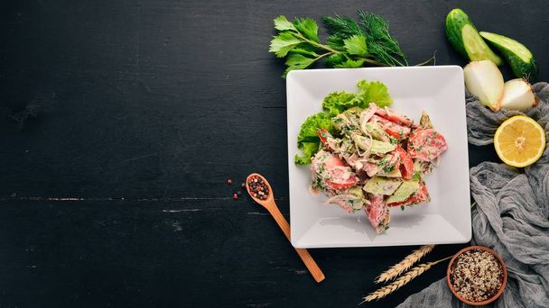 Fresh Vegetable Salad with Walnut Paste. Georgian cuisine. On the old wooden background. Free space for text. Top view. - 写真・画像
