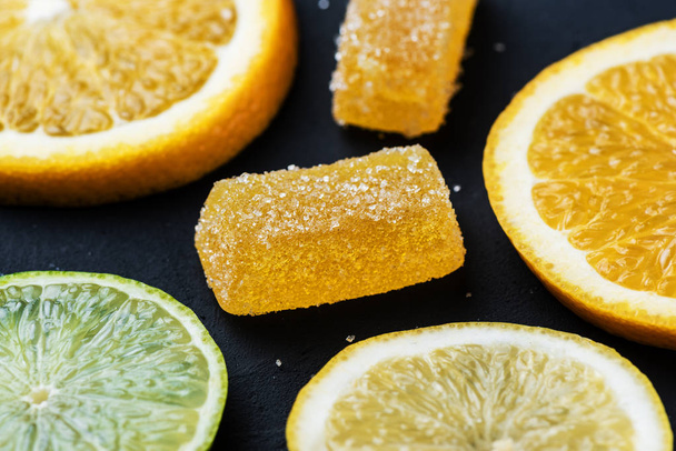 Marmalade next to citrus slices. Lemon, lime, orange. - Photo, Image