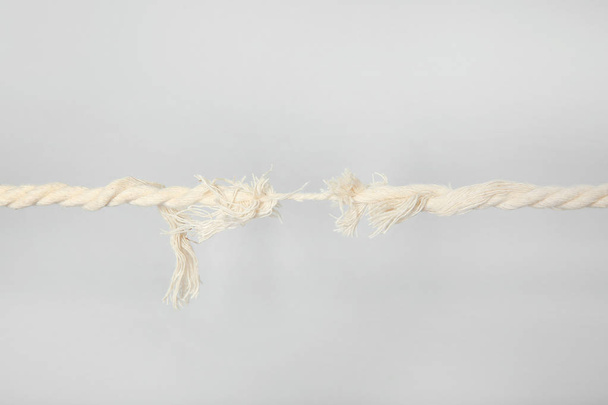Frayed rope at breaking point on gray background - Foto, Imagem