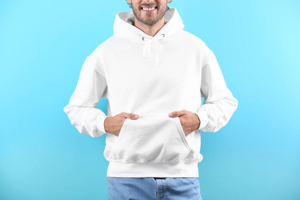 Full length portrait of man in hoodie sweater on light background. Space for design - Foto, Imagen