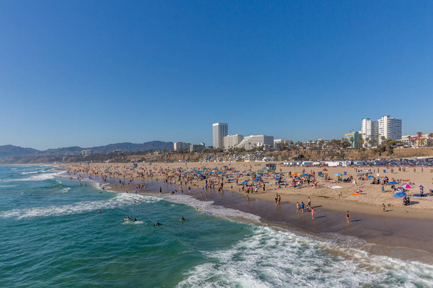 Locals enjoying a sunny day on Santa Monica Beach, in Los Angeles, USA - Photo, Image