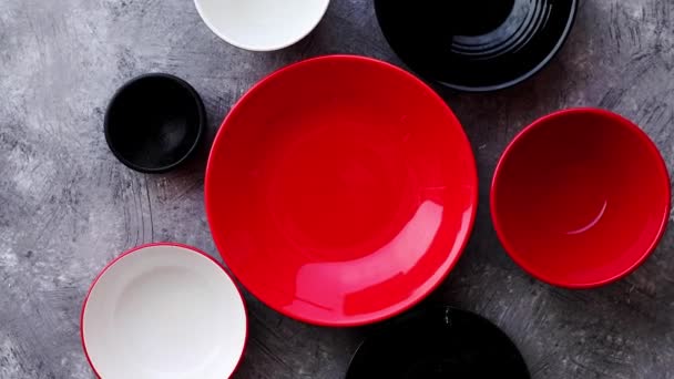 Collection of empty colorful decorative ceramic bowls on grey stone background. - Footage, Video