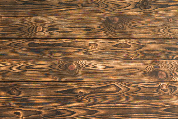 Background texture of rustic brown natural wood with a distinctive woodgrain pattern for use as a design template in a full frame view - Valokuva, kuva
