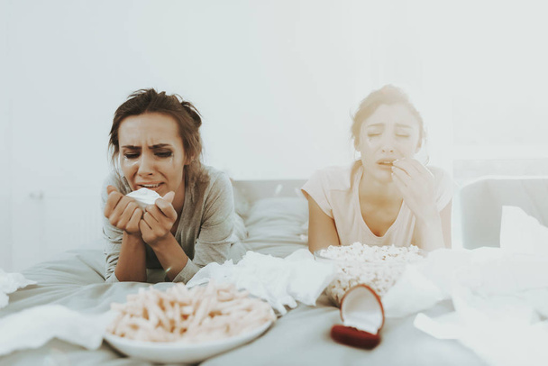 Two Handsome Girls Are Crying At The Hen Party. Unhappy Holiday. Flowed Mascara. Tears On The Face. Disappointed Women. Females In The Bad Mood. Engagement Ring. Popcorn And French Fries. - Foto, Imagen