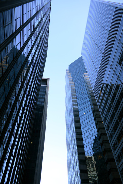 Looking up a skyscraper office block in New York City - Фото, изображение