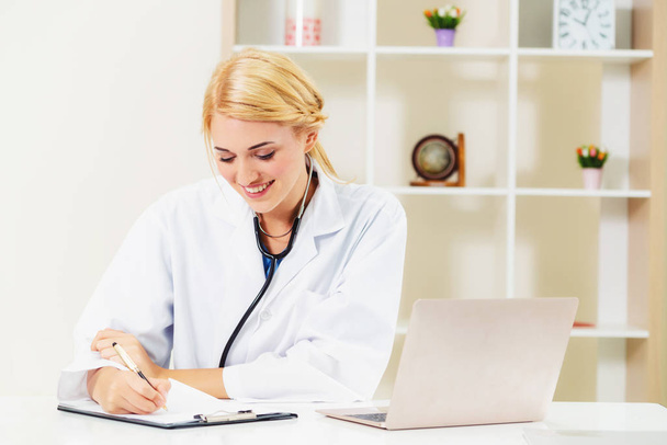 Young female doctor working in hospital office. Medical and healthcare concept. - Photo, Image