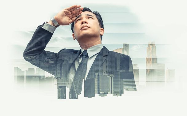 Double exposure - Business leader vision for success, looking away with modern buildings in city background. Concept of talented leadership. - Photo, Image