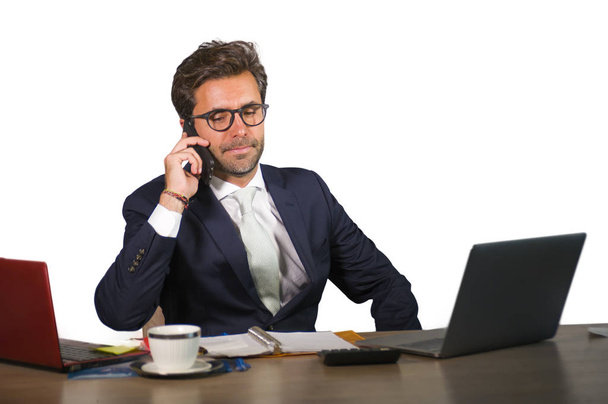 company corporate isolated portrait of young handsome and attractive businessman working at office desk talking on mobile phone confident in finance success and executive lifestyle - Φωτογραφία, εικόνα