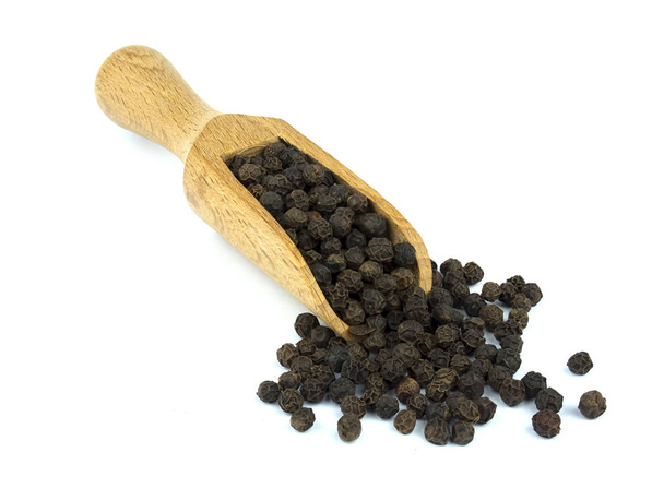 Food ingredients: heap of black pepper in a wooden scoop, on white background - Foto, immagini