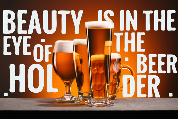 glasses of beer on orange backdrop with "beauty is in the eye of the beer holder" inspiration - Fotoğraf, Görsel