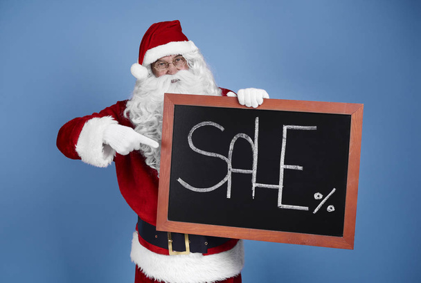 Man in santa claus costume with christmas banner  - Foto, afbeelding