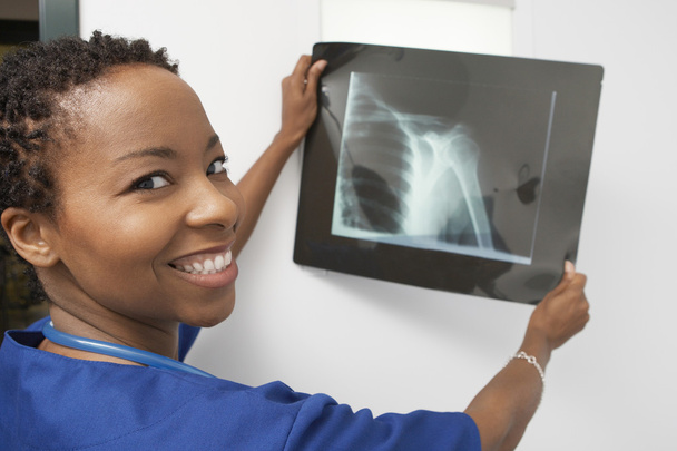 Happy Doctor Holding X-Ray Report - Foto, immagini