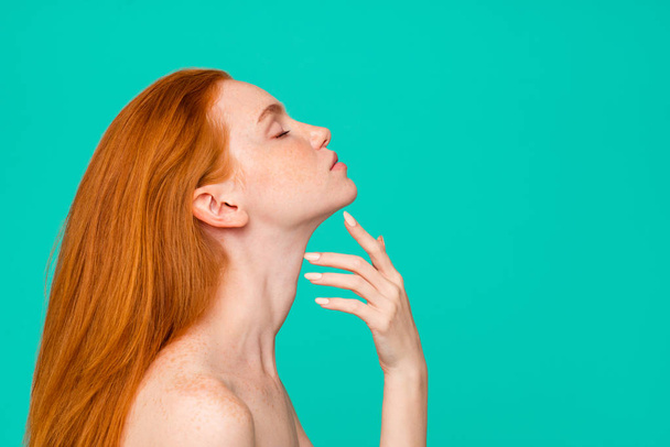 Plastic surgery advertising. Profile side view portrait of nude red-haired girl with pure clear fresh smooth perfect skin, spa, therapy, treatment, copy-space, isolated on green turquoise background - Fotografie, Obrázek